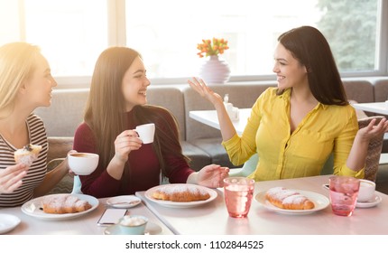 Happy Girls At Restaurant. Friends Having Brunch, Chatting And Gossipping At Cafe