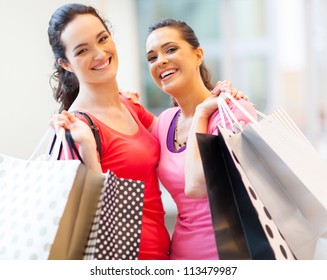 Happy Girls With Shopping Bags In Mall