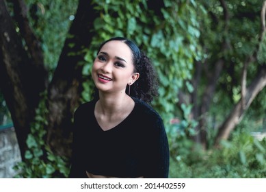 A Happy And Gleeful Young Asian Woman With A Genuine Smile.