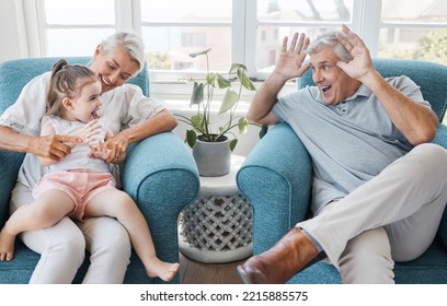 Happy, Grandfather And Grandmother With Child, Excited And Bonding Being Silly, Goofy Or Funny In Living Room At Home. Elderly Man, Senior Woman Or Grandchild Being Playful, Connect Or Laugh Together