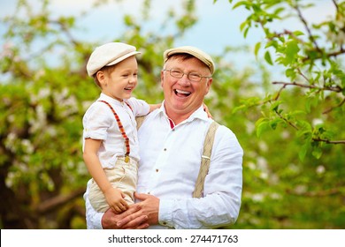 Happy Grandfather And Grandson Having Fun In Spring Garden