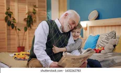 Happy Grandfather And Grandson While Reading Book Sitting At Home Generation Book Happiness Child Reading Kid Man Caucasian Family Happy Childhood Grandchild Slow Motion