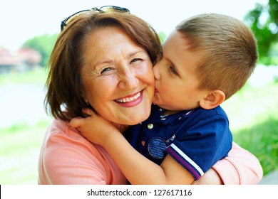 Happy Grandma With Grandson Embracing Outdoor