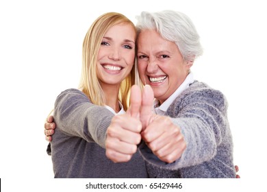 Happy grandma and her granddaughter holding their thumbs up