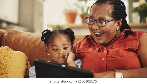 Happy, grandmother and child with tablet at house for streaming movie, bonding and video on social media. Surprise, black family and girl relax with digital for online ebook, comedy game and lounge - Powered by Shutterstock