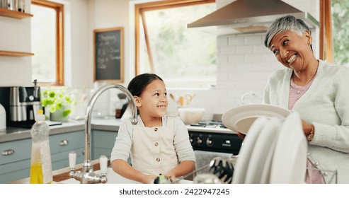 Happy, grandmother and child washing dishes with help, teaching and learning from a senior. Smile, support and an elderly woman and a girl kid cleaning the kitchen together in a house for routine - Powered by Shutterstock