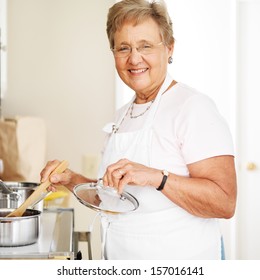 Happy Grandmother Cooking In Kitchen