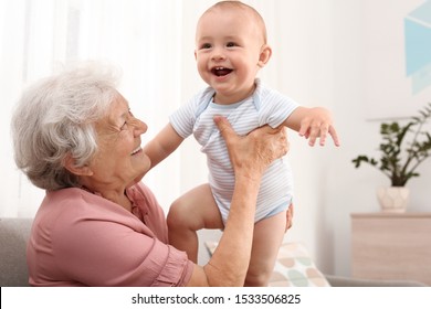 Happy grandmother with little baby at home