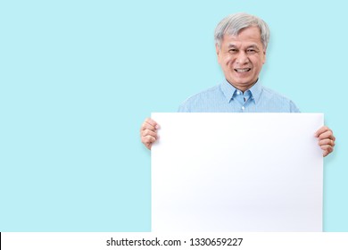 Happy grandpa smiling with white teeth, enjoy moment and holding a blank board. Asian older man showing white blank board for your advertising text message or promotional content. - Powered by Shutterstock