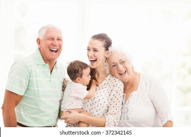 Happy grandparents playing with their grandson at home