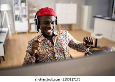 Happy Graphic Designer Listening Music In Headphones At Work - Powered by Shutterstock