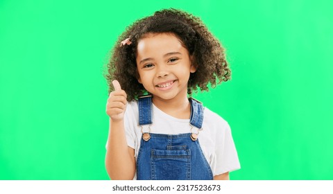 Happy, green screen and face of a child with a thumbs up isolated on a studio background. Winning, success and portrait of a girl kid with an emoji hand gesture for motivation, yes and agreement - Powered by Shutterstock