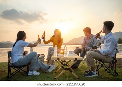 Happy Group Of Asian Friends Play Guitar And Sing Enjoying Camping And Drinking Beer