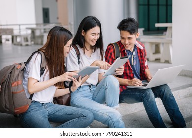 Happy Group of attractive young people using a laptop and tablet, sitting on study table, Social media online and education concept.