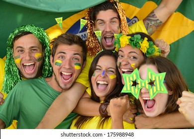 Happy group of Brazilian sport soccer fans amazed celebrating victory together. - Powered by Shutterstock