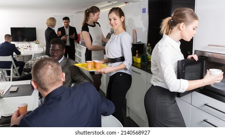 Happy Group Of Business People Chatting While Enjoying Coffee In Break Room