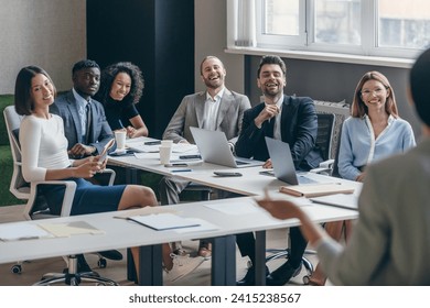 Happy group of business people listening to the speaker during conference in convention center - Powered by Shutterstock