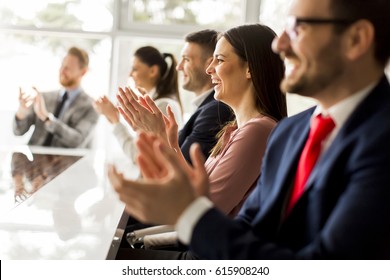 Happy group of businesspeople clapping in office - Shutterstock ID 615908240