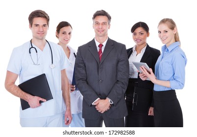 Happy Group Of Businesspeople And Doctors Standing Over White Background