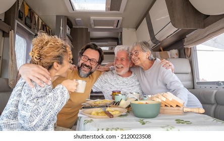 Happy Group Of Caucasian Multigenerational Family Sitting Inside A Camper Van Motorhome Dinette Hugging Enjoying Good Time Together. Lifestyle And Travel Modern People, Vacation Journey Concept