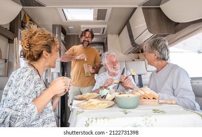 Happy Group Of Caucasian Multigenerational Family Sitting Inside A Camper Van Motorhome Dinette Hugging Enjoying Good Time Together. Lifestyle And Travel Modern People, Vacation Journey Concept