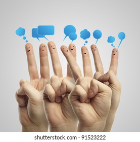 Happy group of finger smileys with social chat sign and speech bubbles. Fingers representing a social network.