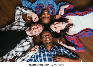 Happy Group Of Four Young Black And White Friends, Pastime Together. International Friendship, Fun, Happiness And Joy, World Unity And Race Equality Concept.