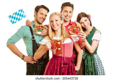 Happy group of friends celebrating Oktoberfest with beer and pretzel