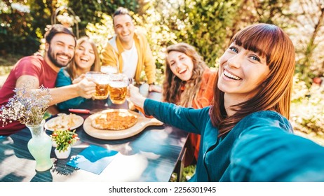 Happy group of friends drinking beer at brewery bar restaurant - Young people having dinner party sitting in pub garden - Life style concept with guys and girls hanging out on summer vacation - Powered by Shutterstock