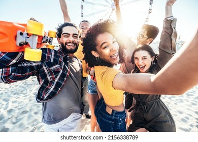 Happy group of friends making beach party dancing together - Multiracial young people enjoying music festival on summer vacation - Summertime holidays concept with guys and girls hanging outside  - Powered by Shutterstock