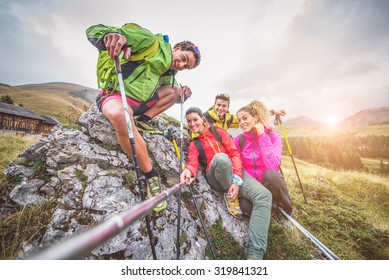 Happy Group Of Friends Photographing Themselves  - Hikers On Excursion In The Nature Having Fun And Taking A Selfie With Action Camera Stick