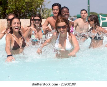 Happy group of friends in a swimmingpool smiling and having fun - Powered by Shutterstock