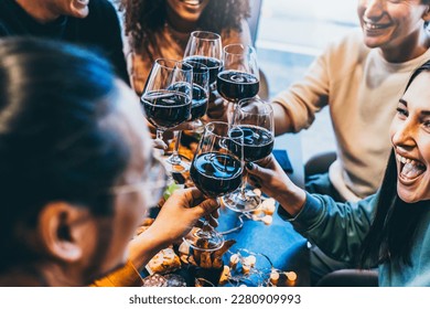 Happy group of friends toasting and drinking red wine together at bar restaurant table- Young multiracial people enjoying at happy hour cheering glasses- Beverage and lifestyle concept with teenager
 - Powered by Shutterstock