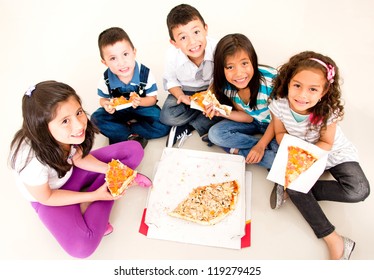 Happy Group Of Kids Eating Pizza And Smiling