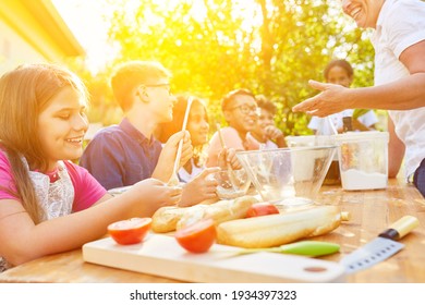 Happy Group Of Kids Learning To Cook In Cooking Class At Summer Camp