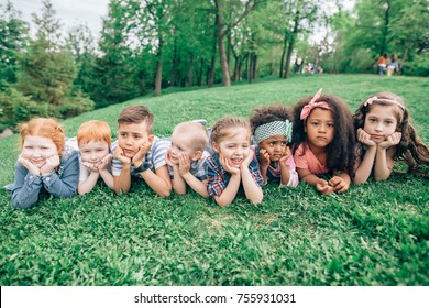 Happy Group Of Kids Playing At The Park. The Concept Of Friendship, Childhood And Intercultural Communication.