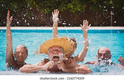 Happy Group Of Mature Friends Enjoying The Outdoor Swimming Pool Together Having Fun Under The Sun. Vacation And Summer Concept