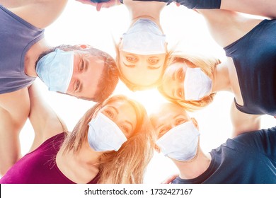 A Happy Group Of Men And Women Practicing Yoga In The Studio In Medical Mask. The Concept Of New Lifestyle Pandemic. Coach And Students In A Circle