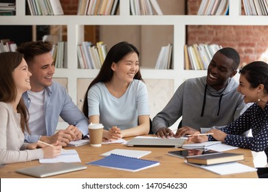 Happy Group Of Mixed Race College Friends Laughing, Joking, Having Fun During Study Break. Smiling Diverse College Teammates Gathered In Library To Discuss Seminar, Project Ideas Or Prepare For Test.