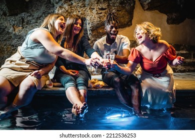 Happy Group Of Multi-ethnic Cheerful Young People Having Fun In The Resort's Spa Relax Cave Having A Party Together And Toasting By Clinking Sparkling Wine - People And Alcohol Lifestyle Concept