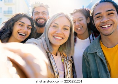  happy group of multiracial friends taking selfie with smartphone outdoors . young beautiful teenagers smiling at the camera , diversity of happy people . Students on campus portrait .  - Shutterstock ID 2206251251