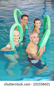 Happy group of people in aqua fitness class in swimming pool
