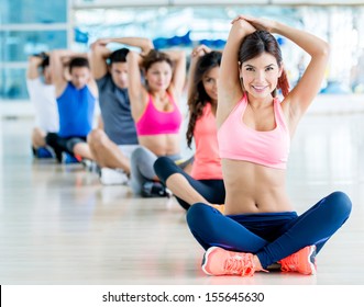 Happy Group Of People Exercising At The Gym