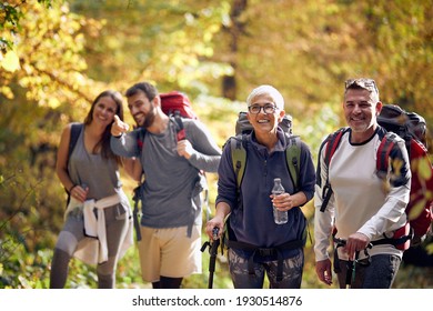 Happy Group Of People Hiking At Autumn In Nature 