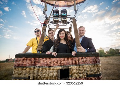 Happy Group Of People Posing In Hot Air Balloon Basket