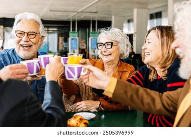 Happy group of senior people enjoying coffee at cafeteria bar. Retired generation community having fun gathered on terrace toasting hot drink. Elderly friendship lifestyle concept. - Powered by Shutterstock