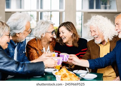 Happy group of senior people laughing and enjoying coffee at cafeteria bar. Retired generation community having fun gathered on terrace toasting hot drink. Elderly friendship lifestyle concept. - Powered by Shutterstock