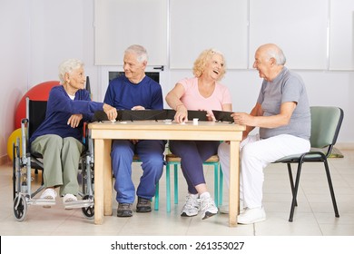 Happy Group Of Senior People Playing Rummy Game In A Nursing Home