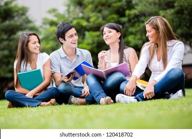 Happy Group Of Students Sitting At The Park Talking