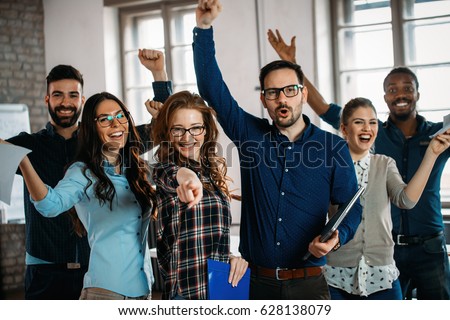 Happy group of successful company employees in office